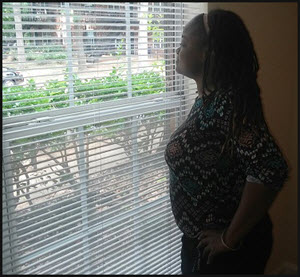 Chandra looks out the window of her new home