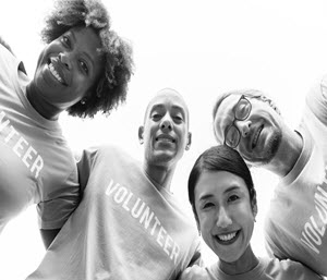 Volunteers smile down on camera